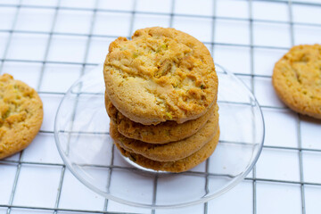 Pistachio and almond cookies on white background.