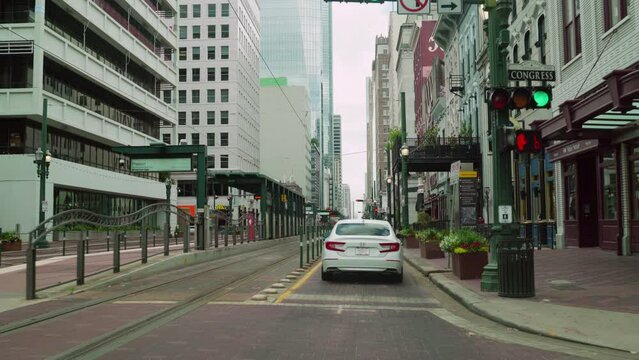 Driving car slowly on Main Street in Downtown of Houston passing Congress Street. Driving pass Preston NB metro station and 990 Congress. Following white car go through the historic Houston areas.