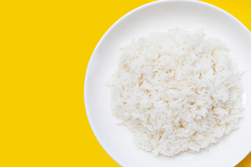 Dish of rice on yellow background.