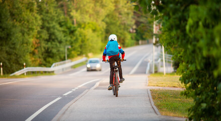 Teenager in the morning hurrying on bicycle to the lesson