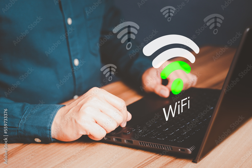Fototapete Man using a computer laptop to connect to wifi but wifi signal is very weak, and waiting to loading digital business data form website, concept technology of waiting for connect to wifi.