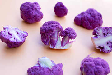 Obraz premium Purple cauliflower on old rose color background.