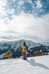 man snowboarder with slovakia flag at ski resort slope