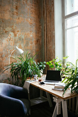 Enjoying working from an atmospheric home office full of green plants.