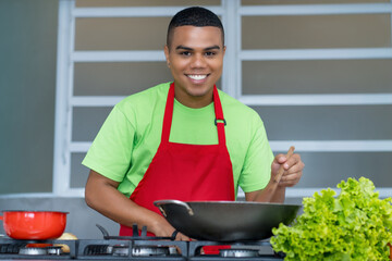 Happy latin american chef apprentice  preparing vegetarian or vegan food