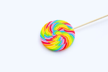 Rainbow lollipop on white background.