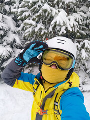 Fototapeta na wymiar smiling woman taking selfie in ski equipment