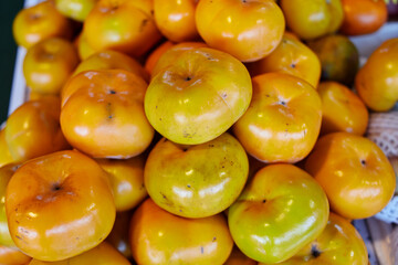 Close-up view of ripe sweet persimmon fruit in the market
