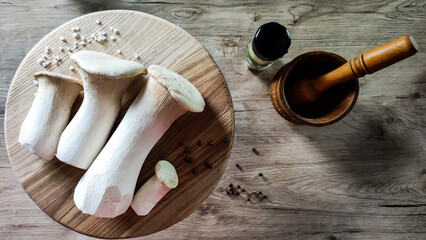 Royal oyster mushrooms or erings on a wooden board.