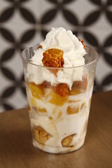 Ripe mango honeycomb candy dessert with whipped cream