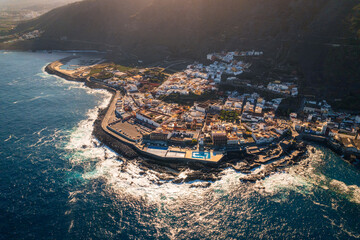 Aerial view of the city of Garachico and the surrounding coast. Sunny weather highlights the colors of the water.