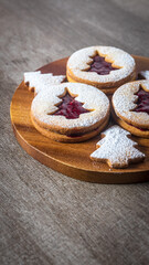 Linzer cookies with christmas tree shape on a wooden table