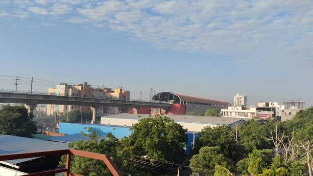 Time lapse footage shot at Mansarovar Metro Station with white clouds and blue sky 