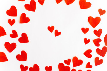 Valentine's Day background with red paper cut out hearts on white background. Top view. Holiday background.