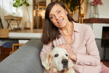 Happy senior woman as a pensioner with her retriever