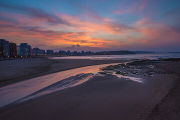 Landscape of the city and beach of Gijón at sunset