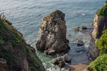 Idyllic beach landscape with rocks in Gijón