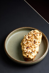 Top view of sandwich with fried hazelnuts and cream on top