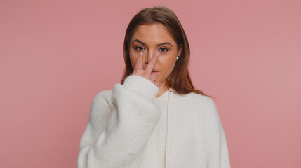 I am watching you. Caucasian woman in white sweater pointing at her eyes and camera, show I am...