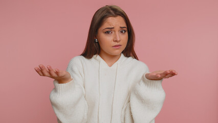 What Why. Sincere irritated adult woman raising hands in indignant expression asking reason of failure demonstrating disbelief irritation by troubles. Young confused girl isolated on pink background