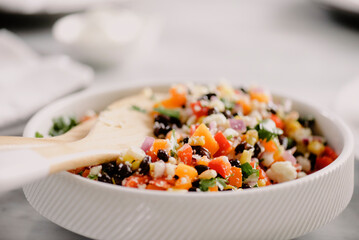 Close-up of salad in bowl with wooden spoons on table