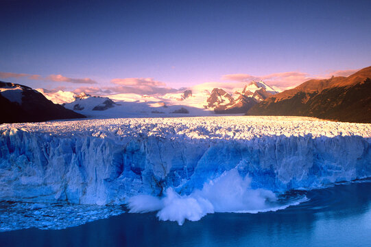 A serac breaks of the Moreno Glacier at sunrise in Patagonia, Argentina.