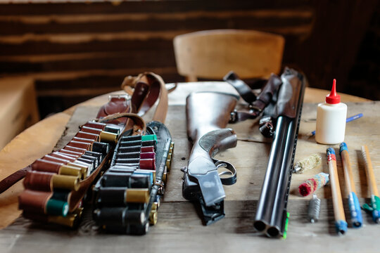 Close up of disassembled shotgun with ammunition and cleaning kit on table, Tikhvin, Saint Petersburg, Russia