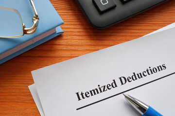 Documents about Itemized deductions on the wooden surface.