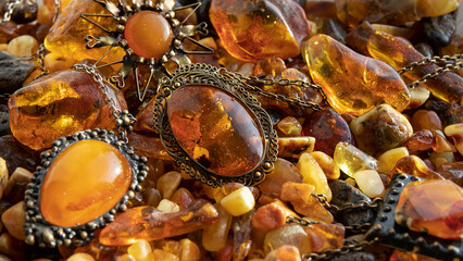 Shiny Baltic amber old jewelry close up. Natural bright amber stones. Vintage background. Orange...
