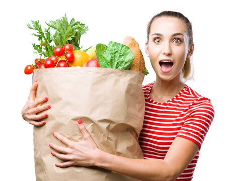 Cheerful Young Woman Holding A Grocery Bag Filled With Vegetable