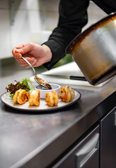 man chef cooking fried shrimp on kitchen