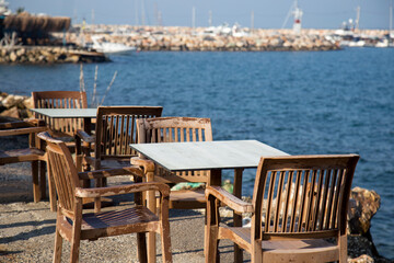 cafe on the beach with old empty tables 