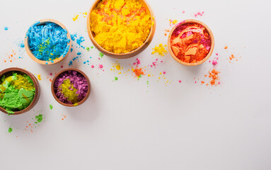 Fototapeta na wymiar Happy Holi decoration, the indian festival.Top view of colorful holi powder on white background.