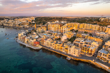 Fototapeta premium Marsaskala townscape at sunrise, Malta. Aerial drone view