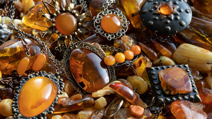 Old amber jewelry close up.  Amber brooches, pendants and beads on the amber stones.  Amber...