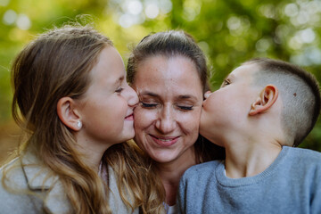 Portrait of happy family with her children in nature.