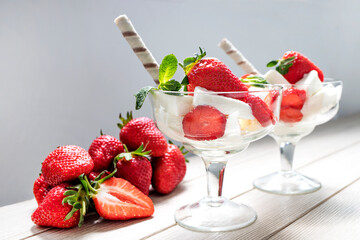Vanilla ice cream and fresh strawberries close-up. Side view.