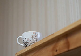 Low-angle view of a mug on the wooden table