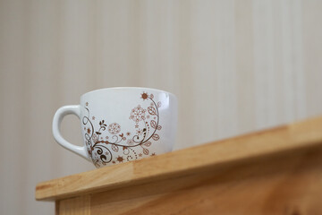 Low-angle view of a mug on the wooden table