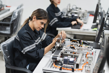 Engineer caucasian woman learning repair electric board in class