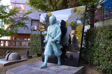 A Japanese stone statue at Tomioka Shrine with copyspace