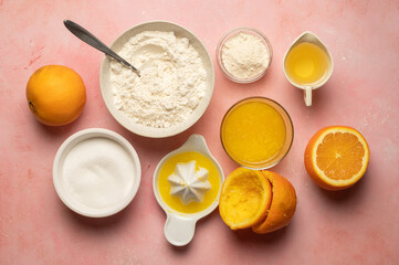 Fototapeta na wymiar Squeezed orange fruit juice, ingredients for cooking, baking orange cake, sugar, flour, milk, copy space