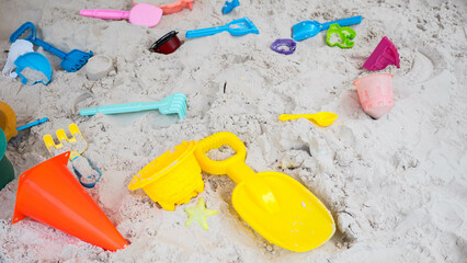 Colorful toys beach on sand.
top view.
