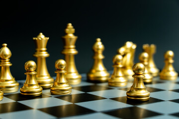 Gold pawn is on the first move in chess game on black background (Concept for business decision, start or beginning project)