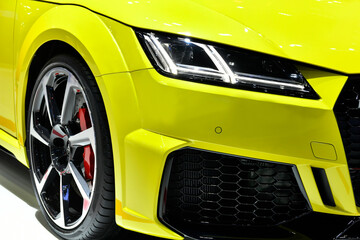 Front headlights of modern yellow car 