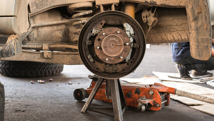 Old and rusty car's suspension parts.
Change the old disc brake and caliper on car.