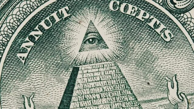 Mason sign symbol of the all-seeing eye sign rotates on a one dollar bill close-up. US banknote in macro with pyramid and eye on top. New world order, elite. Concept inflation, economy, conspiracy.
