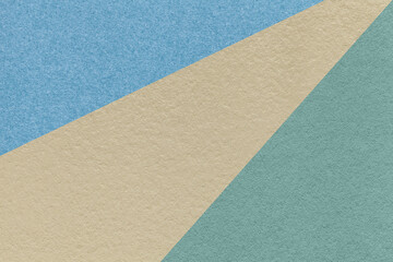 Fototapeta na wymiar Texture of old craft beige, blue and turquoise color paper background, macro. Vintage abstract cerulean cardboard.