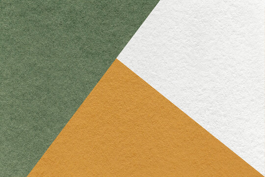 Texture of craft white, olive and orange shade color paper background, macro. Vintage abstract green cardboard