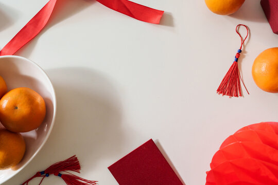 Background of thankful present Lunar New Year. Chinese traditional holiday. mandarin orange with red pocket money. Chinese New Year vacation concept